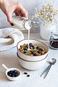 Granola with blueberries and milk