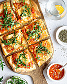 Pizza with tomatoes, cheese and arugula