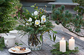 Christmas bouquet of Christmas rose and branches of pine, spruce, mistletoe and hazelnut