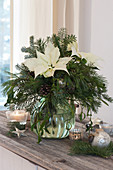 Christmas bouquet with white poinsettias and branches of fir, pine, spruce, and mistletoe