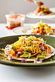Fish tacos with grilled chilean sea bass, avocado, tomatoes, red onion and cheese