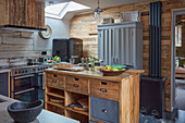 Rustic kitchen with wooden kitchen island and metal bar stools