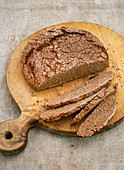 Classic sourdough bread, cut on a wooden board