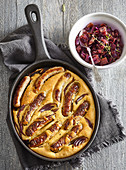Gratinated Bavarian sausages in beer dough with onion chutney