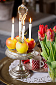 Apples as candle holders on a silver etagere