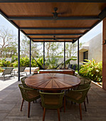 Round wooden tale on roofed terrace in summer