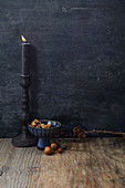 An arrangement of nuts with a candle