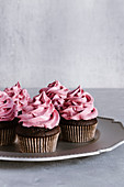 Chocolate cupcakes with black currant marshmallow frosting