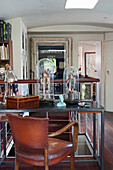 Old desk with collector's items and leather upholstered chair