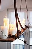White pillar candles on suspended, DIY candle chandelier