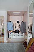 Open wardrobe with clothes rails and drawer cabinet
