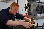 Apprentice setting up a milling machine