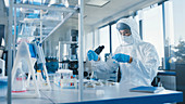 Scientist using a micropipette in a laboratory