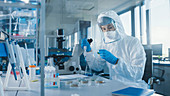 Scientist using a micropipette in a laboratory