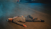 Man lying on the pavement after traffic accident