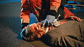Team of paramedics providing help to an injured man