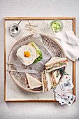 Classic club sandwich and a sandwich with fried egg