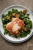 Prosciutto and parmesan chicken with kale caesar