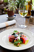 Garden tomato, bresaola and rosemary goat s cheese salad with purple basil