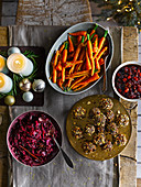 Ginger and orange-glazed baby carrots, Triple nut and apple stuffing balls, Festive red cabbage