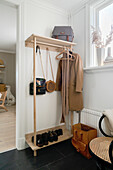 Coat rack in white hallway