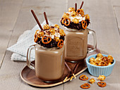 Peanut chocolate shake with popcorn, pretzels and caramel sauce