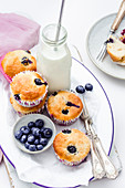 Blueberry muffins and bottle of milk