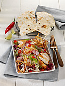 Salad with turkey strips, radishes, red cabbage and tortillas