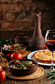 Georgian cuisine, meat and vegetables on a wooden background