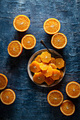 Plated orange slices on a blue background