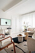 Bright living room with coffee tables, armchair and console table