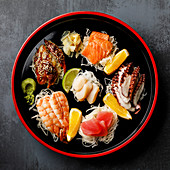 Sashimi sushi set with daikon and lemon