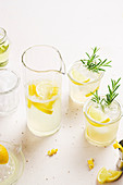 Fresh lemonade garnished with lemon and rosemary