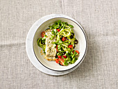 Courgette noodles with cod cooked on a baking tray