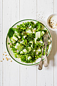 Healthy green salad with edamame and pine nuts