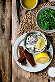 Pickled sardines in oil with lemon and rye bread, Wakame seaweed salad
