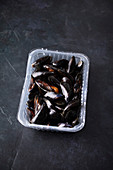 Fresh raw mussels in a plastic tray