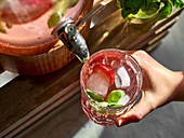 Strawberry and basil lemonade from a drink dispenser