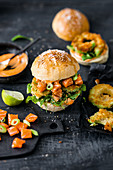 Poké burger with salmon, sriracha mayonnaise, fried avocado and seaweed