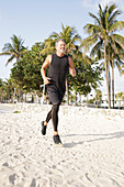 A grey-haired man jogging in black sports clothes