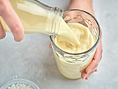 Pouring lupine milk into a glass