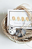 Easter nest with painted eggs and greeting card