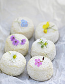 Sancerre cheese with wild flowers decoration on white paper