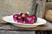 Red onions in white plate