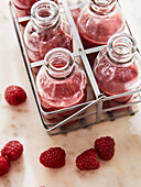 Raspberry smoothie in bottles