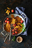 Sweet potato pancakes with tomatoes in an aluminium pan