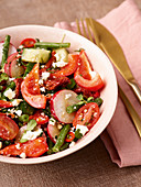 Fresh bean salad with tomatoes, radishes and vegan feta substitute