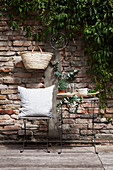 Seating area with Mediterranean greenery and brick wall