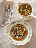 Goose consommÃ© (broth) with herb gnocchi