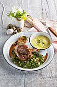 Baked lamb knee with creamy spinach